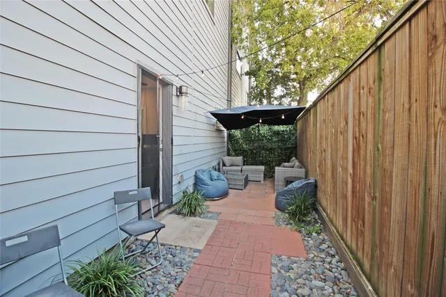 a backyard of a house with outdoor seating