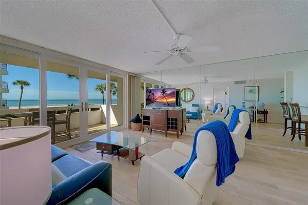 a living room with furniture a rug and a flat screen tv