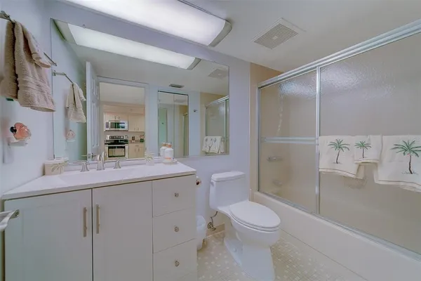 a bathroom with a shower a toilet and a sink