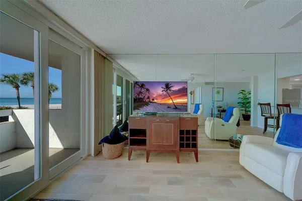 a living room with furniture and a large mirror