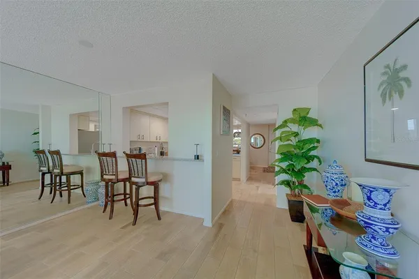 a dining room with furniture and a potted plant
