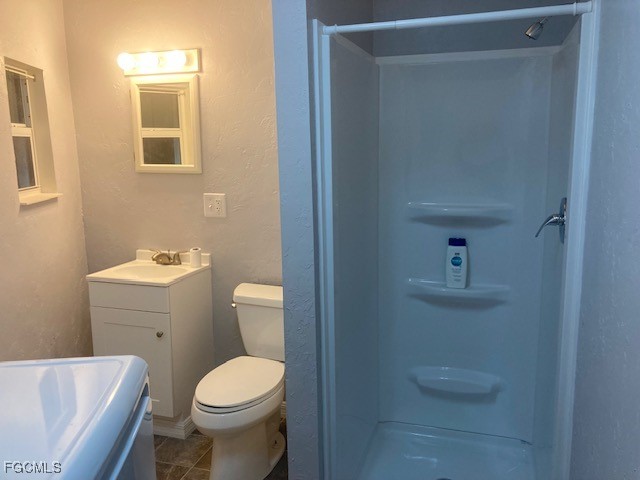 19681 Summerlin Road, Unit J197 Fort Myers, FL 33908 - Photo 19 of 22 a white toilet sitting next to a bathroom sink and vanity