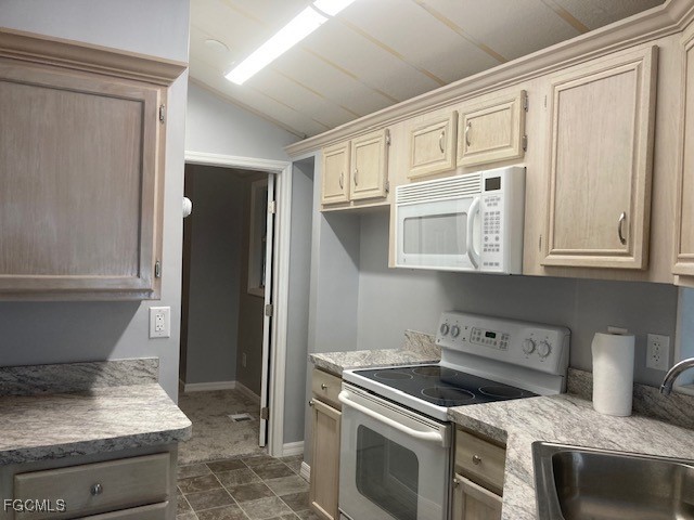 19681 Summerlin Road, Unit J197 Fort Myers, FL 33908 - Photo 6 of 22 a kitchen with a stove and a refrigerator