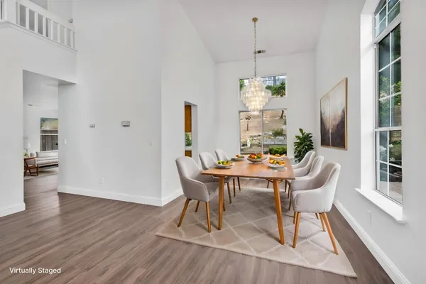 a view of a dining room with furniture window and wooden floor