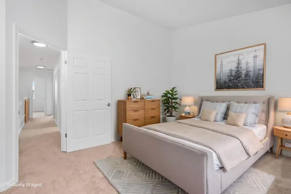 a bedroom with a bed and a potted plant