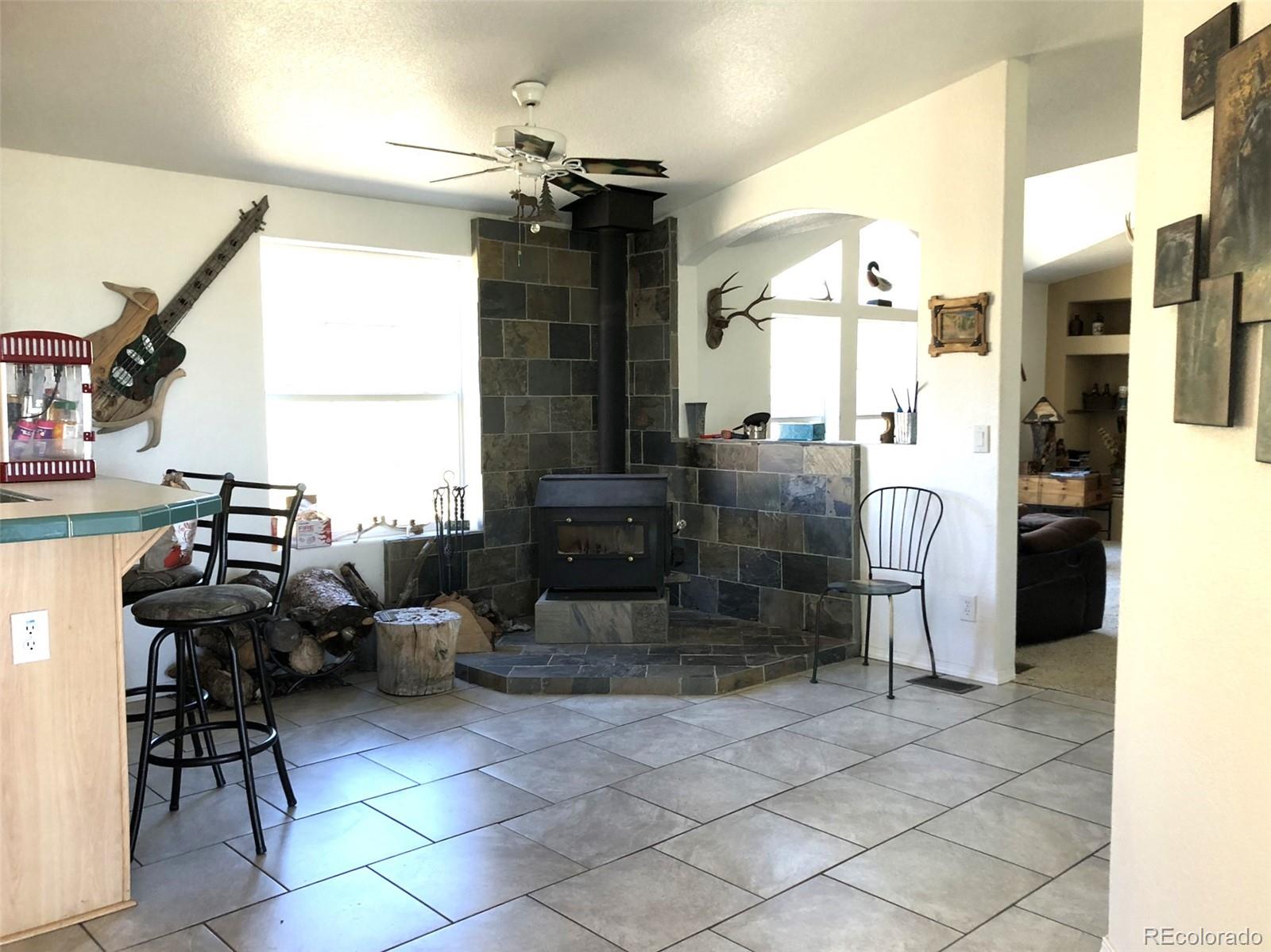 1983 Arapahoe Road Hartsel, CO 80449 - Photo 14 of 39 a living room with couches a dining table and chairs with wooden floor