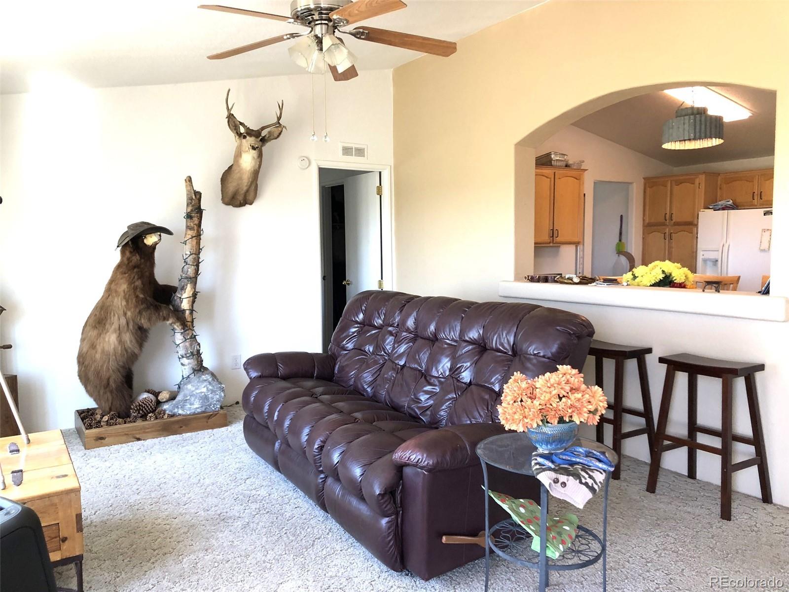 1983 Arapahoe Road Hartsel, CO 80449 - Photo 16 of 39 a living room with furniture and a chandelier