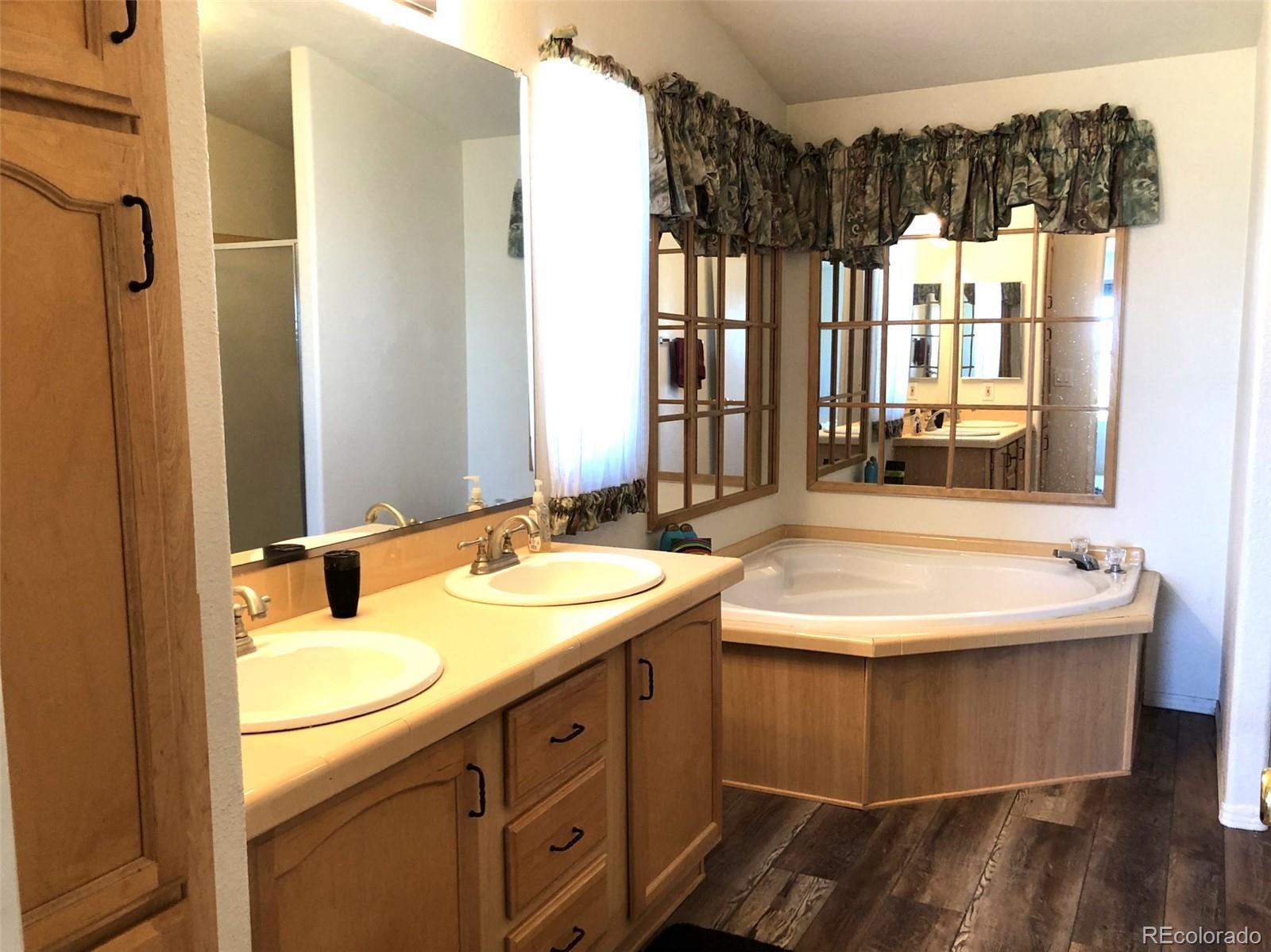 1983 Arapahoe Road Hartsel, CO 80449 - Photo 22 of 39 a bathroom with a sink and a mirror