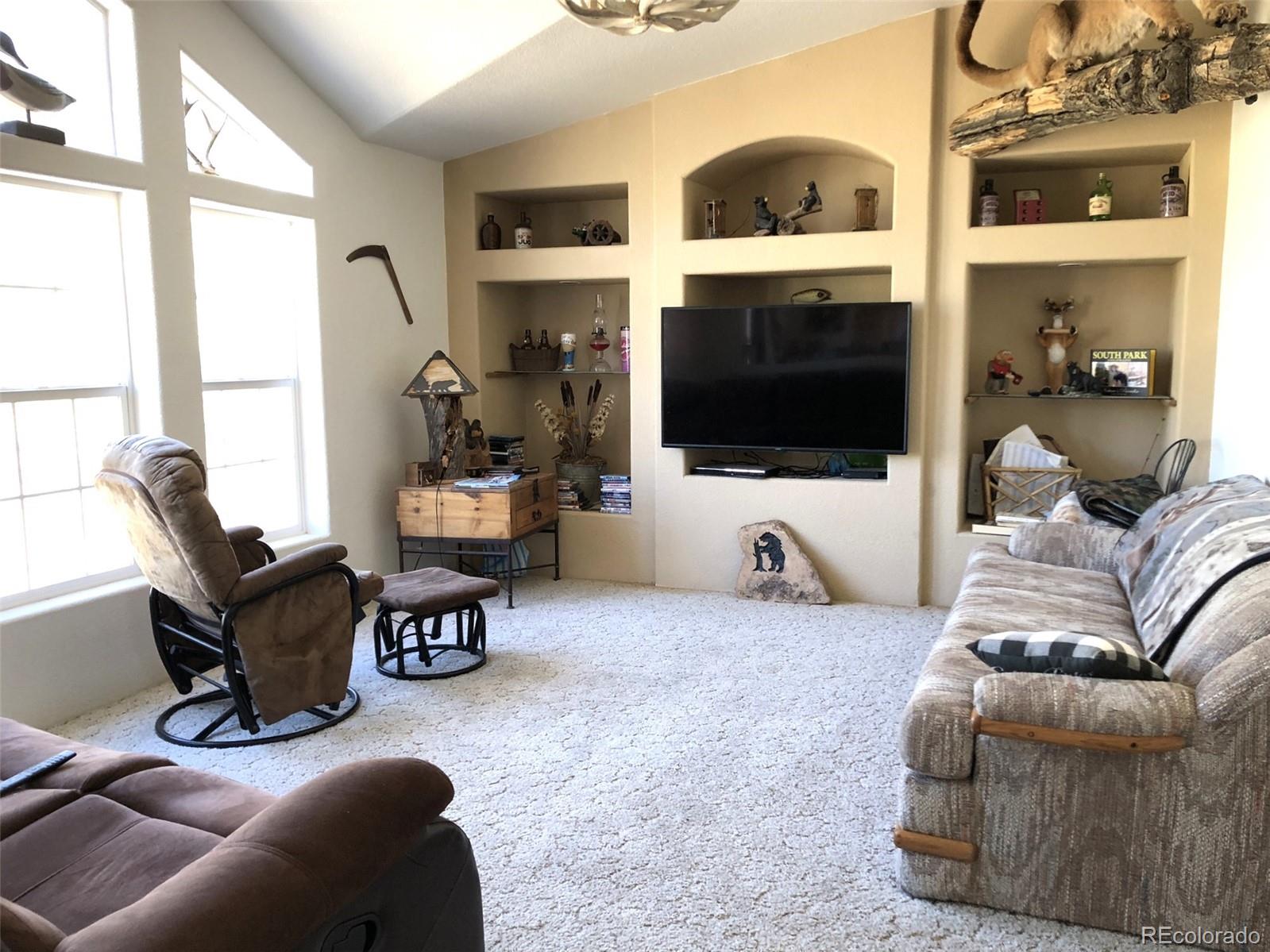1983 Arapahoe Road Hartsel, CO 80449 - Photo 6 of 39 a living room with furniture and a flat screen tv