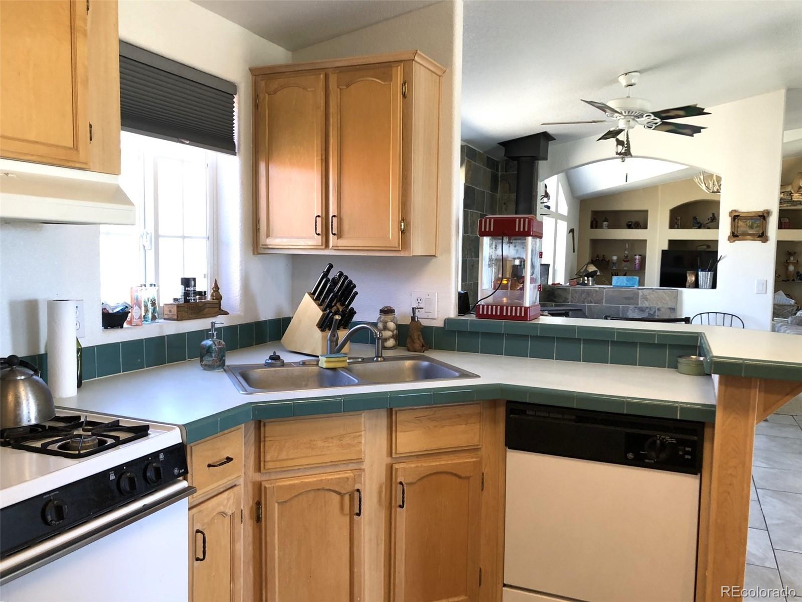 1983 Arapahoe Road Hartsel, CO 80449 - Photo 8 of 39 a kitchen with stainless steel appliances a sink stove and cabinets