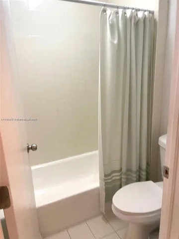 a bathroom with a toilet and a bathtub