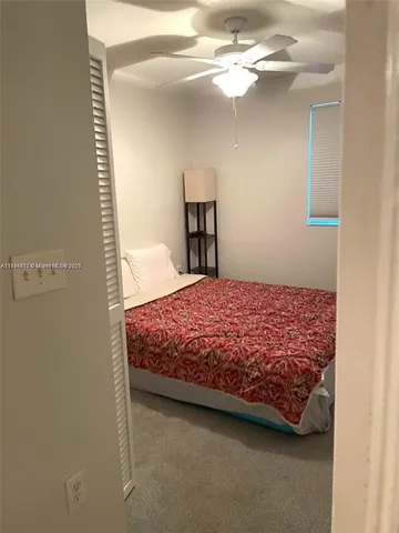 a bedroom with a bed and chandelier