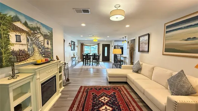 a living room with fireplace furniture and a flat screen tv