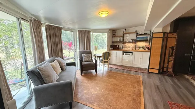 a living room with furniture and a large window