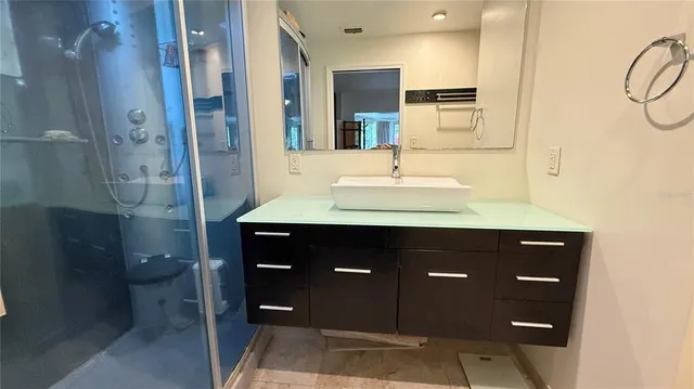 a bathroom with a sink vanity and a mirror