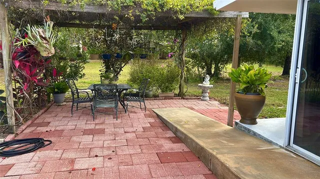 a view of a chairs and table in the patio