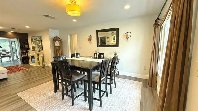 a view of a dining room with furniture and window