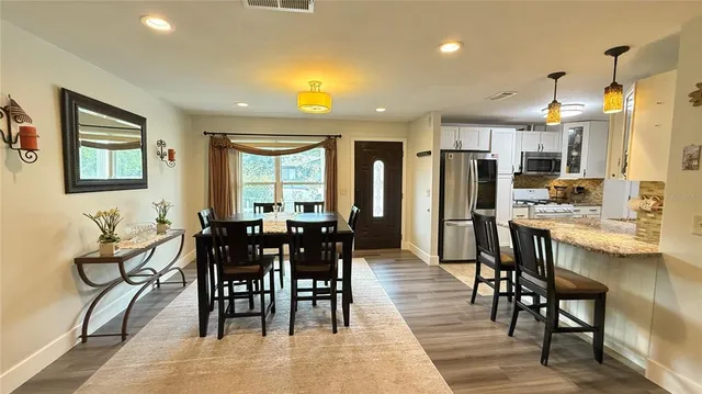 a view of a dining room with furniture and window