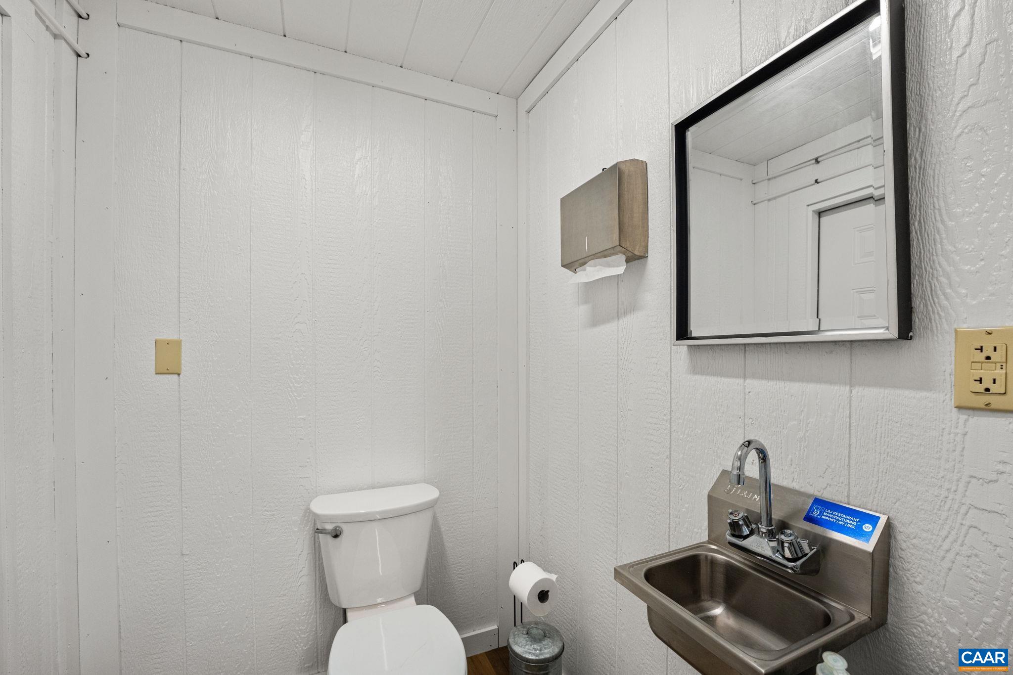 12145 South Constitution Route Scottsville, VA 24590 - Photo 21 of 22 a bathroom with a toilet sink and mirror