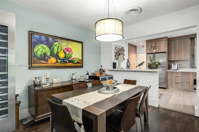 a view of a dining room with furniture a chandelier and wooden floor