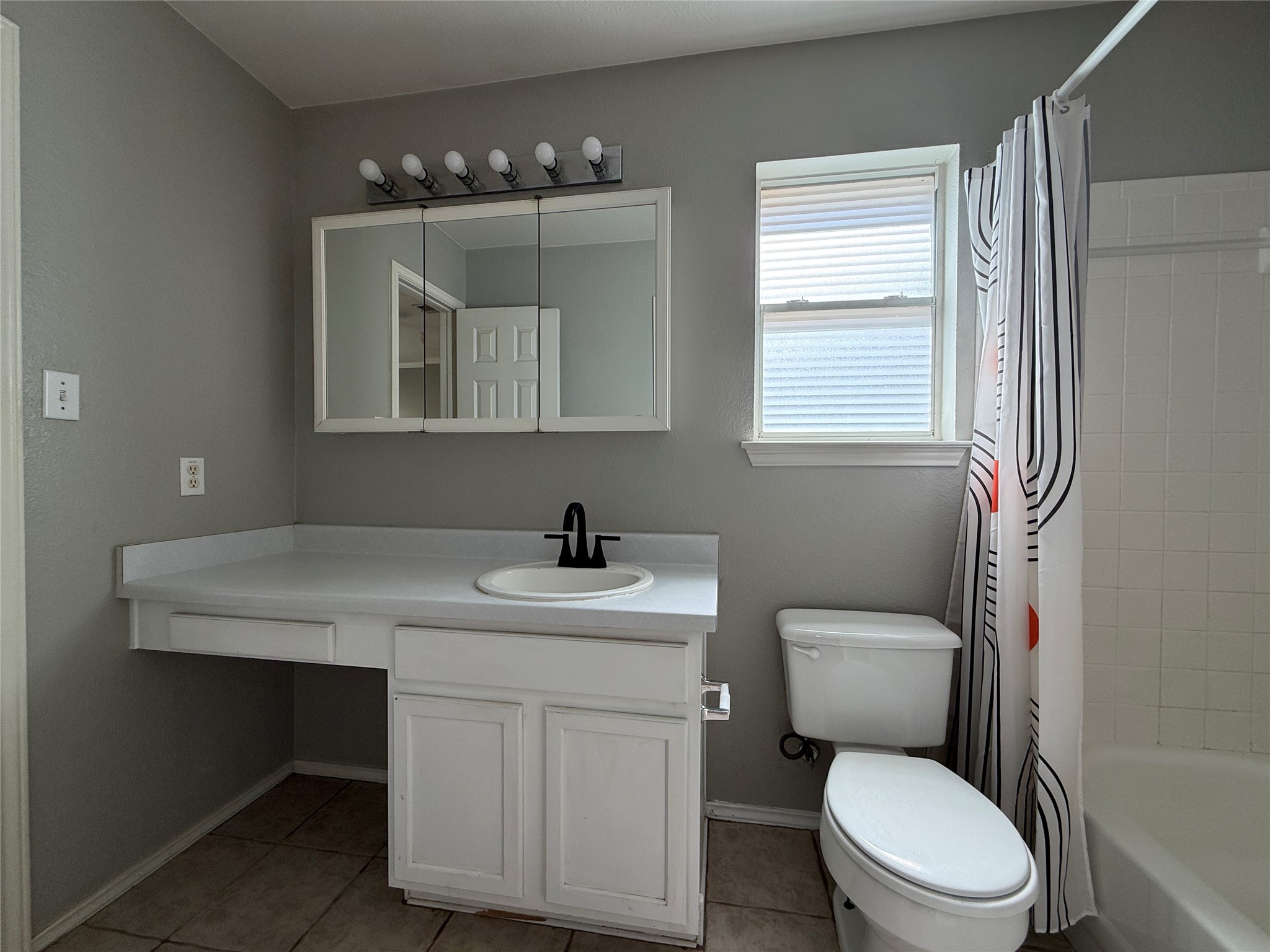 2120 Jester Farms Road Round Rock, TX 78664 - Photo 11 of 28 Functional bathroom features a bright window and sleek vanity with ample counter space.
