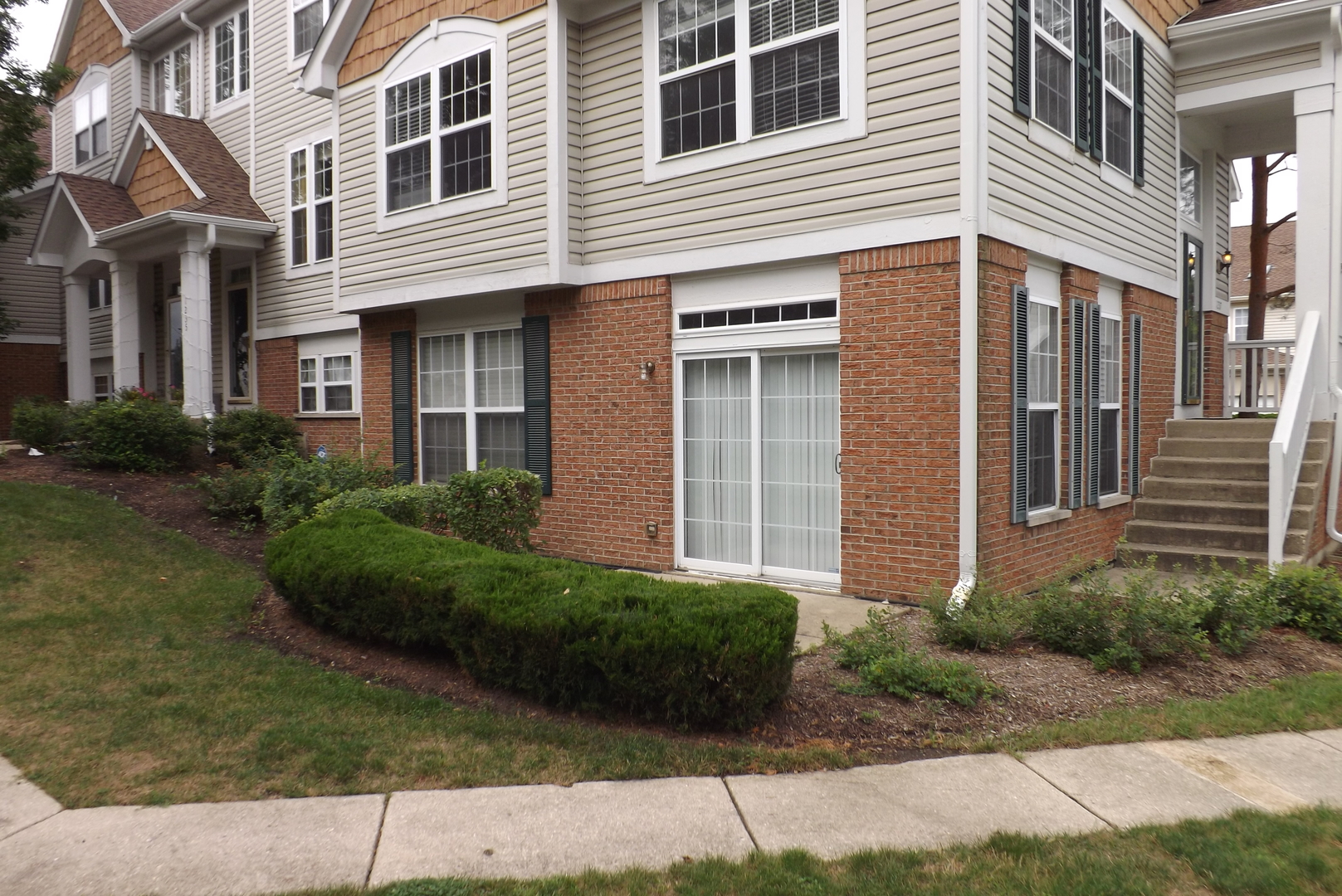 1237 Georgetown Way Vernon Hills, IL 60061 - Photo 2 of 16 a view of a building with a yard