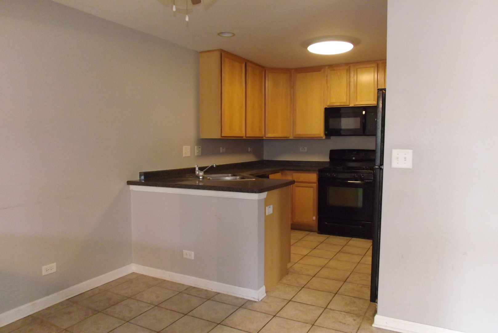 1237 Georgetown Way Vernon Hills, IL 60061 - Photo 8 of 16 a kitchen with a sink a stove cabinets and a window