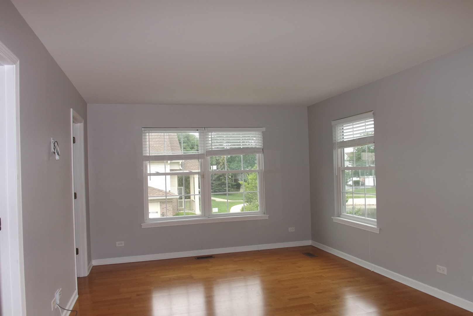 1237 Georgetown Way Vernon Hills, IL 60061 - Photo 10 of 16 a view of an empty room with wooden floor and a window