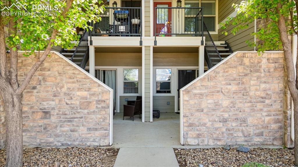 5800 Tower Road, Unit 108 Denver, CO 80249 - Photo 1 of 34 Lower-level patio area featuring concrete flooring and a stone-clad privacy wall
