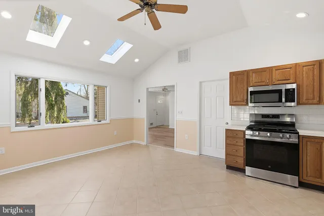 a view of a kitchen with microwave and stove top oven