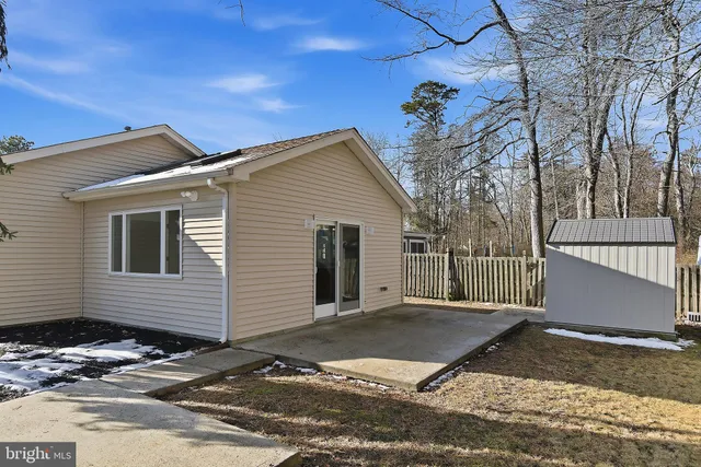 a front view of a house with a tree