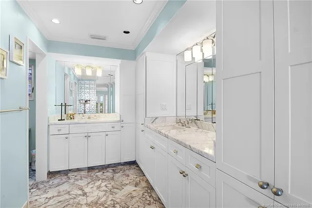 a spacious bathroom with a granite countertop sink mirror and a bathtub