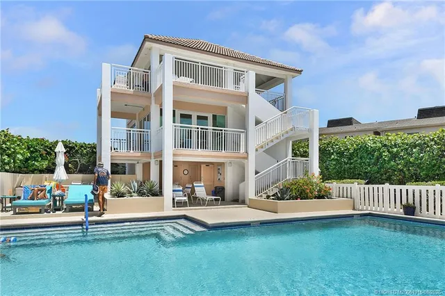 a front view of a house with a yard table and chairs