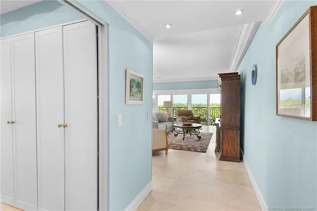 a view of a living room and a window in kitchen