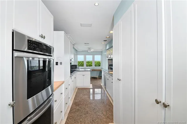 a kitchen with cabinets and stainless steel appliances