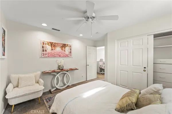 a bedroom with a bed and ceiling fan