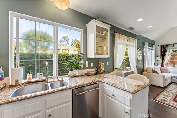 a kitchen with a sink and large window