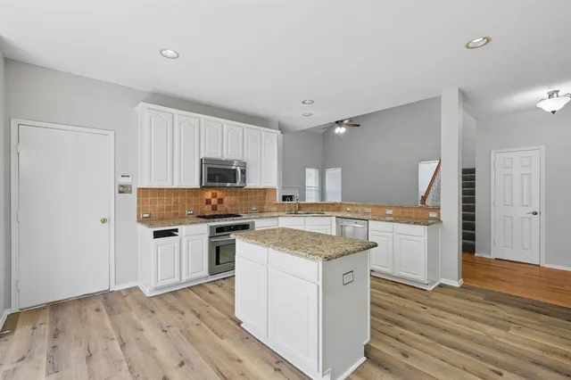 a kitchen with a stove a sink and a refrigerator