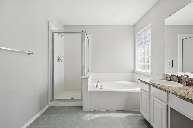 a bathroom with a bathtub sink and mirror