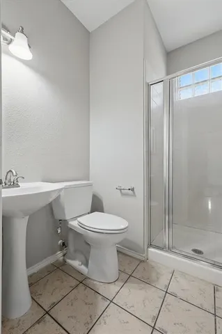 a bathroom with a toilet sink and shower