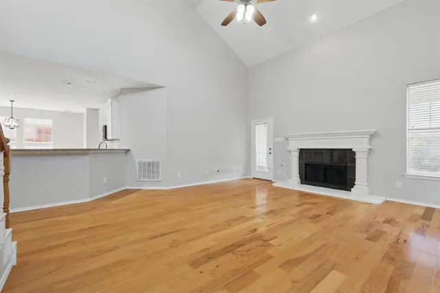 an empty room with a fireplace and window