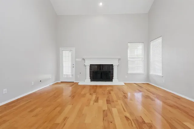 a view of empty room with a fireplace
