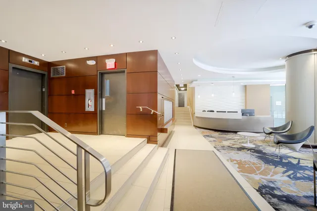 a living room with a bed and glass door