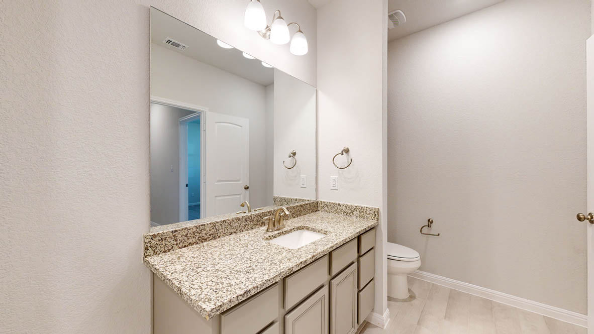 808 Gauge Road Thorndale, TX 76577 - Photo 27 of 31 A pristine powder room offers a spacious vanity with granite counters and a large mirror.