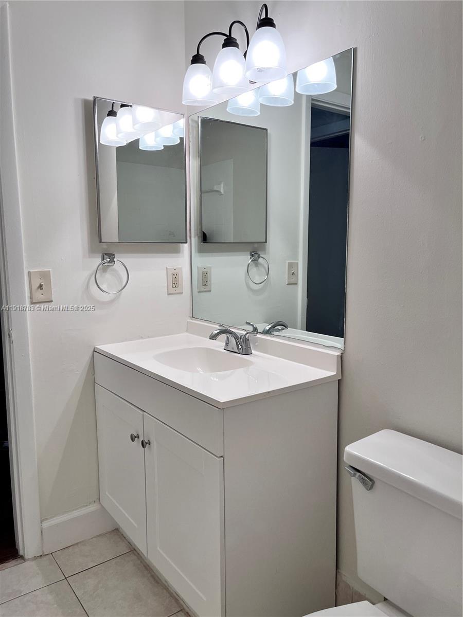 3281 East Golf Boulevard, Unit 12 Pompano Beach, FL 33064 - Photo 14 of 21 a bathroom with a sink and a mirror