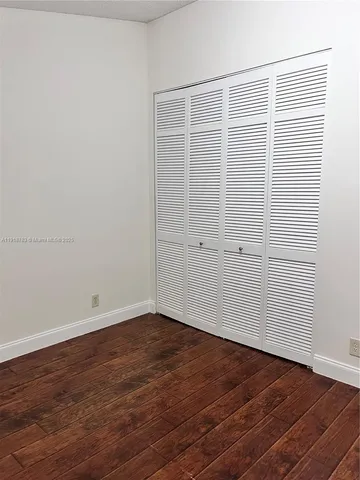 an empty room with wooden floor