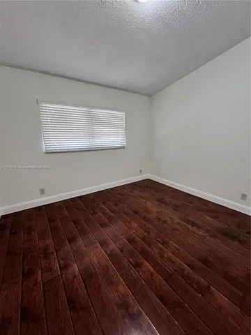 a view of wooden floor in an empty room