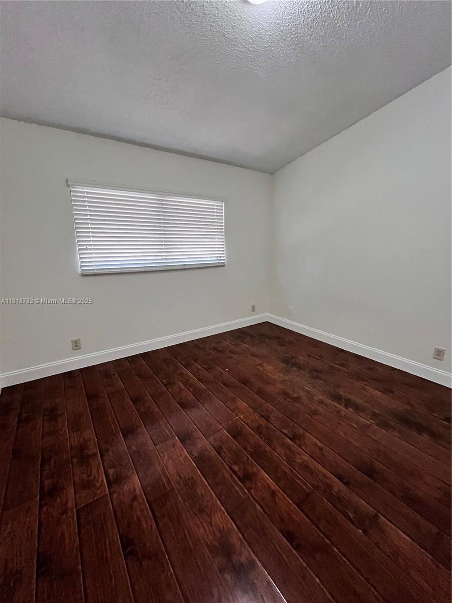3281 East Golf Boulevard, Unit 12 Pompano Beach, FL 33064 - Photo 18 of 21 a view of wooden floor in an empty room