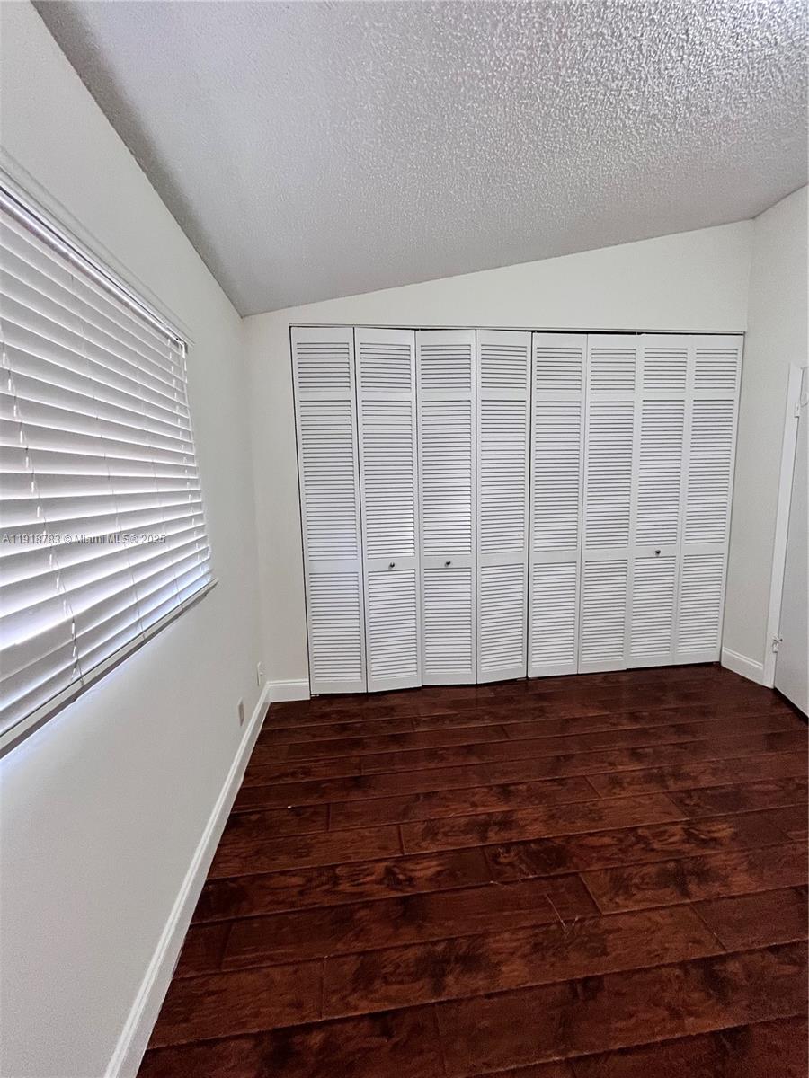 3281 East Golf Boulevard, Unit 12 Pompano Beach, FL 33064 - Photo 19 of 21 a view of a room with wooden floor