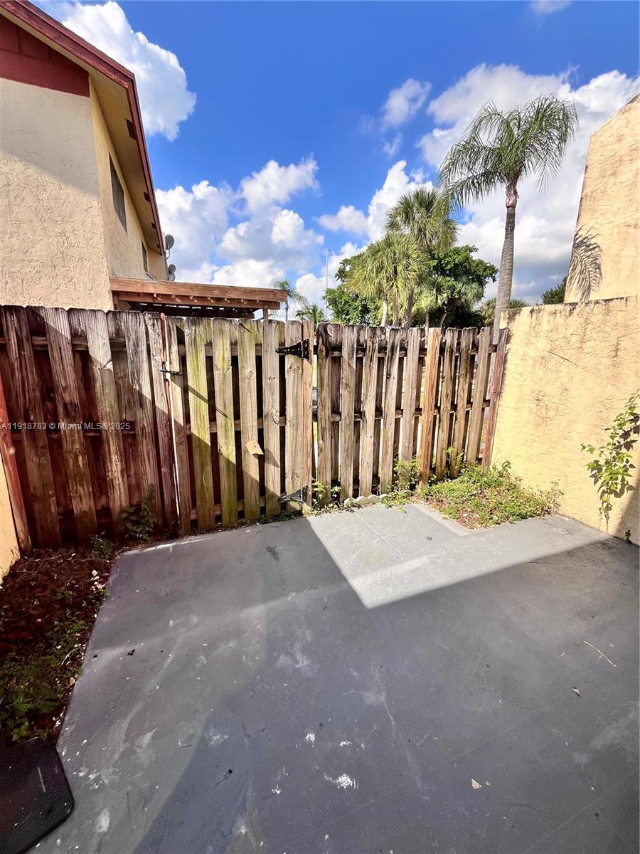 3281 East Golf Boulevard, Unit 12 Pompano Beach, FL 33064 - Photo 20 of 21 a view of a wooden fence